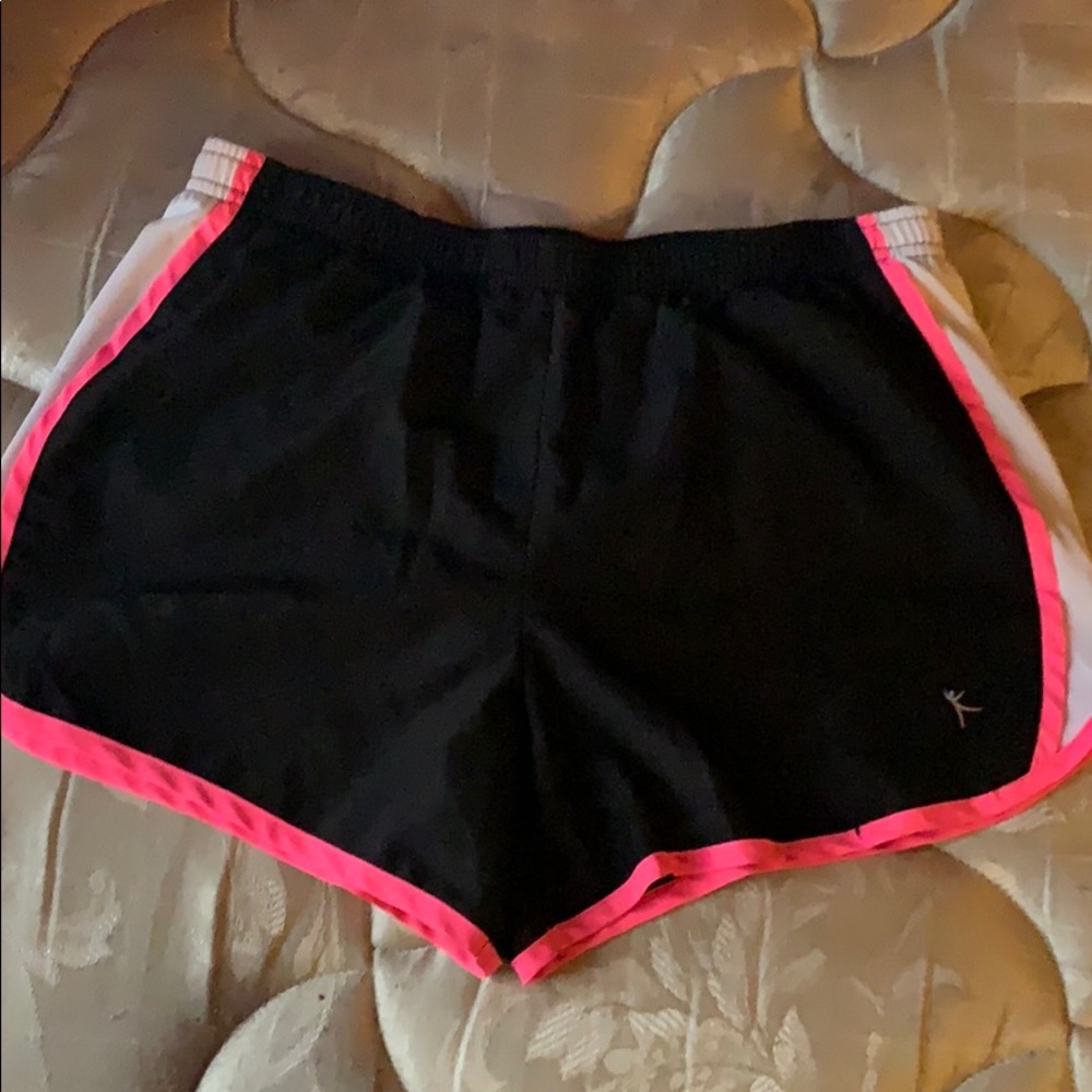 Black swim shorts with pink and white trim.